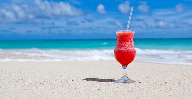 Cocktail de fruits rouges posé sur une plage de sable de la Côte d'Azur.